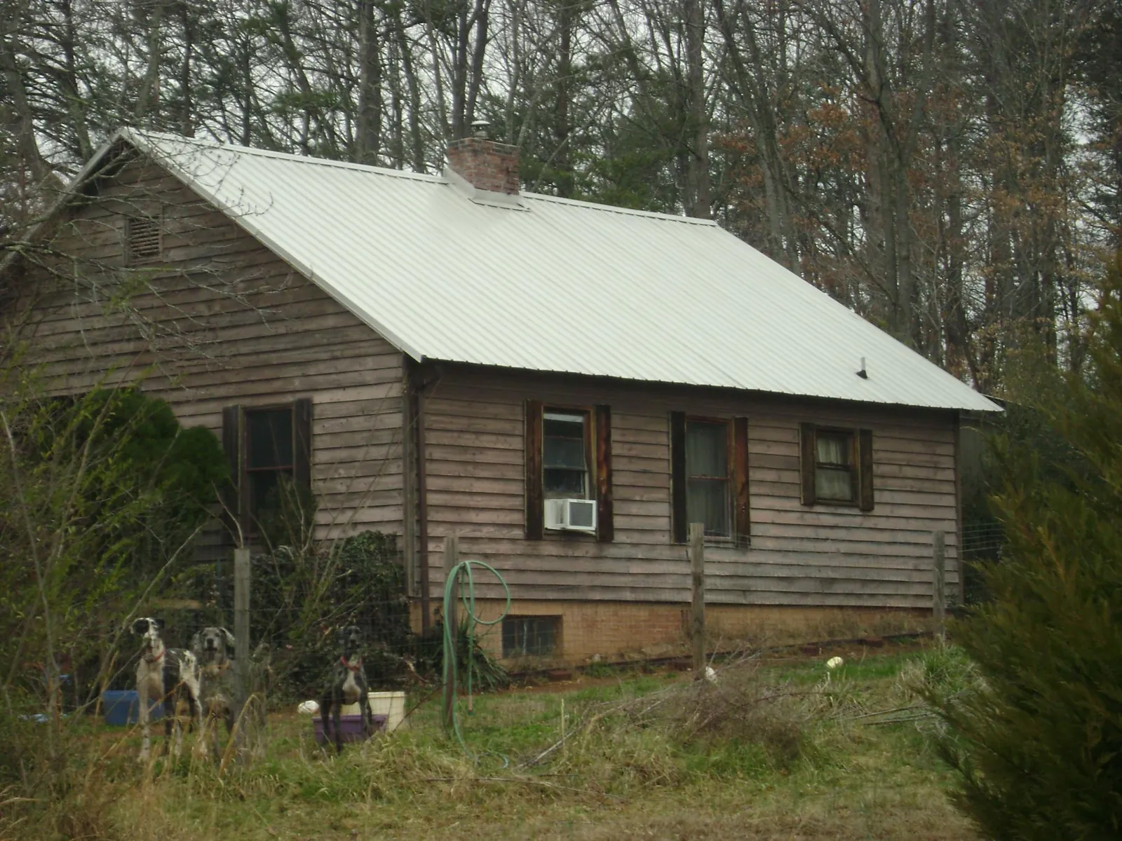 White metal roof on an old wood sided farmhouse, from a Metal Roof Installation job in Flournoy